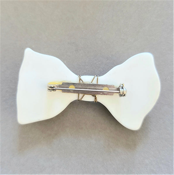 White Plastic Bow Pin with Enameled Flowers
