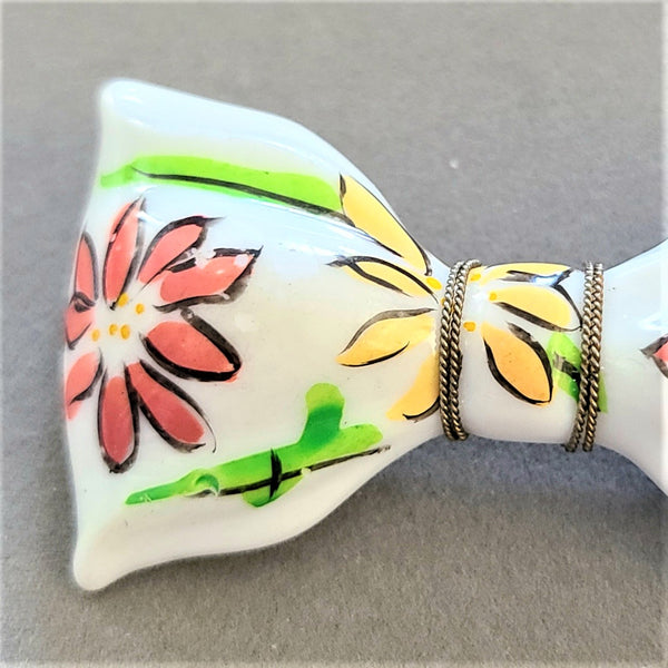 White Plastic Bow Pin with Enameled Flowers