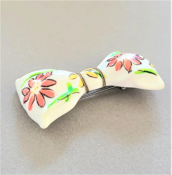 White Plastic Bow Pin with Enameled Flowers
